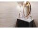 Stylish powder room featuring a vanity with white stone countertop and decorative lighting at 510 Glenwood Ave # 602, Raleigh, NC 27603