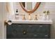 A beautifully designed bathroom vanity with a decorative faucet and rounded mirror at 510 Glenwood Ave # 602, Raleigh, NC 27603