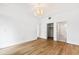 Open bedroom with modern chandelier, and views to closet and bathroom at 510 Glenwood Ave # 602, Raleigh, NC 27603