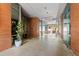 A wide brick-walled building entrance featuring decorative plants and unique ceiling lights at 510 Glenwood Ave # 602, Raleigh, NC 27603