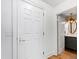 Hallway features a white door and trim leading to a well-lit bathroom at 510 Glenwood Ave # 602, Raleigh, NC 27603