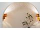 An elegant recessed wall featuring stylish sconces and a leafy plant at 510 Glenwood Ave # 602, Raleigh, NC 27603