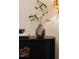 A stylish cabinet is decorated with a metallic vase and leafy plant accents at 510 Glenwood Ave # 602, Raleigh, NC 27603
