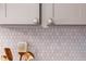 Close up of kitchen cabinet hardware, backsplash, and utensil holders at 510 Glenwood Ave # 602, Raleigh, NC 27603