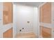 Bright laundry room with plank floors and white paneled doors for storage at 510 Glenwood Ave # 602, Raleigh, NC 27603