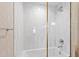 Modern bathroom featuring a white tiled shower with gold trim at 510 Glenwood Ave # 602, Raleigh, NC 27603