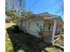 View of the exterior of the home; light green siding and an outside sitting area at 529 Solar Dr Dr, Raleigh, NC 27610