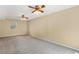 Finished basement with two ceiling fans, and paneled walls at 5401 Kaplan Dr, Raleigh, NC 27606