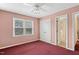 A bedroom featuring a ceiling fan, closet, and window for natural light at 5401 Kaplan Dr, Raleigh, NC 27606
