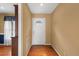 A cozy foyer with hardwood floors, neutral paint, and a stylish front door with decorative glass at 5401 Kaplan Dr, Raleigh, NC 27606