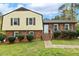 Traditional two-story home featuring a brick facade and vinyl siding, complimented by a well-maintained lawn and landscaping at 5401 Kaplan Dr, Raleigh, NC 27606