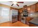 Bright kitchen with stainless steel appliances and wood cabinets at 5401 Kaplan Dr, Raleigh, NC 27606
