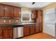 Open kitchen with stainless steel appliances and wood cabinets at 5401 Kaplan Dr, Raleigh, NC 27606