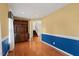 Bright and open living space featuring hardwood floors, stylish wainscoting, built-in shelving, and natural light at 5401 Kaplan Dr, Raleigh, NC 27606