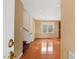 Inviting entryway with hardwood floors, neutral walls, and staircase, offering a glimpse into an adjacent living space at 5401 Kaplan Dr, Raleigh, NC 27606