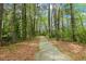 Nature path surrounded by trees, a scenic outdoor community trail at 5401 Kaplan Dr, Raleigh, NC 27606