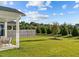 Expansive backyard featuring lush green grass, mature trees, and a wooden privacy fence at 6 S Summerhill Rdg, Clayton, NC 27520