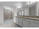Bright bathroom featuring double sinks, granite countertops, and a glass-enclosed shower with tiled walls at 6 S Summerhill Rdg, Clayton, NC 27520