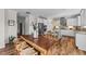Cozy dining area overlooking a modern kitchen with stainless steel appliances and stone countertops at 6 S Summerhill Rdg, Clayton, NC 27520