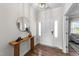 Inviting entryway featuring a console table, wood floors, and a bright white front door at 6 S Summerhill Rdg, Clayton, NC 27520