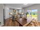 Kitchen with an island, granite countertops, stainless-steel appliances, and open layout to a dining area at 6 S Summerhill Rdg, Clayton, NC 27520