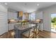 Bright kitchen featuring granite countertops, a kitchen island with bar seating, and modern appliances at 6 S Summerhill Rdg, Clayton, NC 27520
