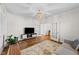 Sitting room with a decorative rug, hardwood floors, french doors, and modern furnishings at 6 S Summerhill Rdg, Clayton, NC 27520