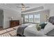 Spacious main bedroom featuring tray ceilings, a fan, and large windows that provide plenty of natural light at 6 S Summerhill Rdg, Clayton, NC 27520