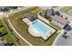 Aerial view of community pool with lap lanes, lounge chairs, and nearby recreation facilities at 6 S Summerhill Rdg, Clayton, NC 27520