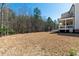 Expansive backyard with view of the screened porch at 609 Meyers Place Ln, Holly Springs, NC 27540