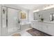 Elegant bathroom with double vanity, glass shower, and separate soaking tub by a window at 609 Meyers Place Ln, Holly Springs, NC 27540