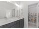 Bathroom with double sinks, marble countertops, and a separate shower area offering luxury and convenience at 609 Meyers Place Ln, Holly Springs, NC 27540