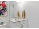 Powder room featuring a white vanity with a marble countertop and decorative accents at 609 Meyers Place Ln, Holly Springs, NC 27540