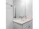 Bathroom with a single sink vanity with a white marble countertop and white cabinets at 609 Meyers Place Ln, Holly Springs, NC 27540