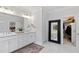 Bright bathroom features double sinks, large mirror, and closet at 609 Meyers Place Ln, Holly Springs, NC 27540