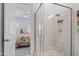 Modern bathroom featuring a glass-enclosed shower with a view into the bedroom at 609 Meyers Place Ln, Holly Springs, NC 27540