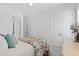 A bright bedroom with a bed, a window, and a closet, all designed for comfort and functionality at 609 Meyers Place Ln, Holly Springs, NC 27540