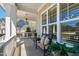 Charming covered porch with outdoor seating and a view of the front yard and neighborhood at 609 Meyers Place Ln, Holly Springs, NC 27540