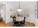 Bright dining area with a round table, shuttered windows, and view of the kitchen, great for Gathering dinners at 609 Meyers Place Ln, Holly Springs, NC 27540