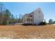 Exterior of home showing the screened porch and spacious backyard at 609 Meyers Place Ln, Holly Springs, NC 27540