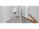 Upstairs hallway with neutral carpeting, leading to bedrooms and bathrooms with natural light at 609 Meyers Place Ln, Holly Springs, NC 27540