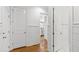 Hallway with hardwood floors leading to the kitchen, showing the transition between spaces at 609 Meyers Place Ln, Holly Springs, NC 27540