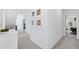 Bright hallway features neutral walls, soft carpet, and decorative framed art at 609 Meyers Place Ln, Holly Springs, NC 27540