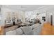 Bright open concept living room showcasing hardwood floors, a comfortable seating arrangement and seamless flow to the kitchen at 609 Meyers Place Ln, Holly Springs, NC 27540
