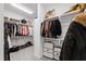Walk-in closet is complete with custom shelving and racks for storage at 609 Meyers Place Ln, Holly Springs, NC 27540