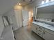 Bright bathroom features a double sink vanity with a marble countertop, and a shower with a patterned curtain at 65 Oglethorpe Ave, Clayton, NC 27527