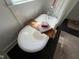 Close-up of a clawfoot tub with a wooden tray and plush towels in a bright bathroom at 65 Oglethorpe Ave, Clayton, NC 27527
