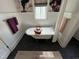 Elegant bathroom featuring a clawfoot tub, floral wallpaper, and modern fixtures at 65 Oglethorpe Ave, Clayton, NC 27527