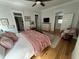 Bright bedroom features hardwood floors, a king-size bed, closet, and doorway to en-suite bathroom at 65 Oglethorpe Ave, Clayton, NC 27527