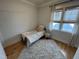 Cozy bedroom featuring a twin bed, a shaggy rug, and natural light from a window at 65 Oglethorpe Ave, Clayton, NC 27527